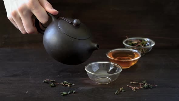 Pouring Chinese Traditional Tea Ceremony on Grey Background