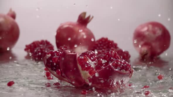 Falling Splitted Pomegranate Into the Water . Slow Motion