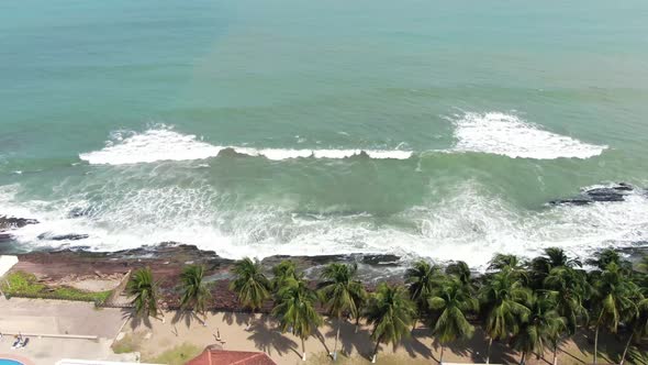 sea waves by house aerial view