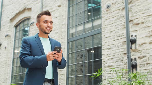 Young successful caucasian businessman works outdoor