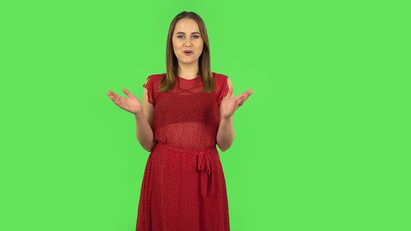 Tender Girl in Red Dress Is Reporting and Telling a Lot of Interesting Information. Green Screen