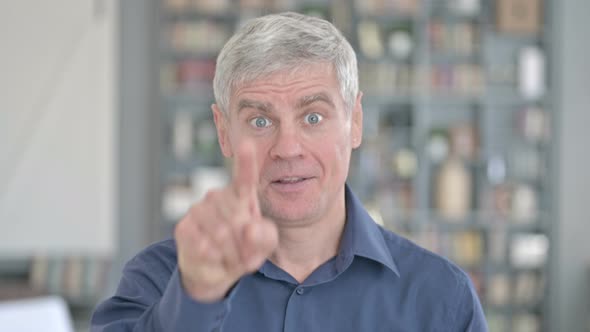 Portrait of Cheerful Middle Aged Man Pointing Finger and Inviting