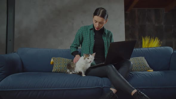 Caring Female Stroking One Eyed Cat on Couch