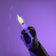 Doctor Pushes The Syringe Glowing With Liquid - VideoHive Item for Sale