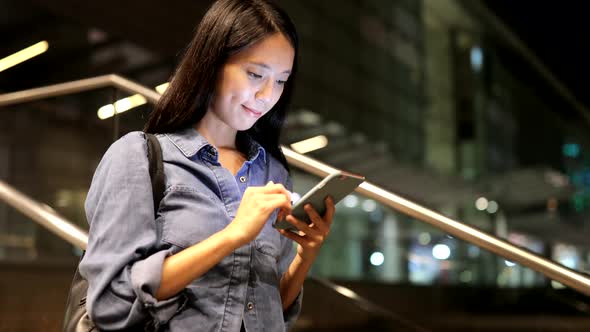 Woman looking at mobile phone in Hong Kong 