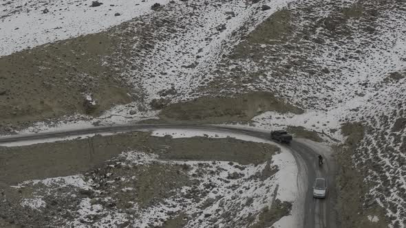 Aerial of car driving on the street with mountain in the of the street at hunza Pakistan. Beautiful