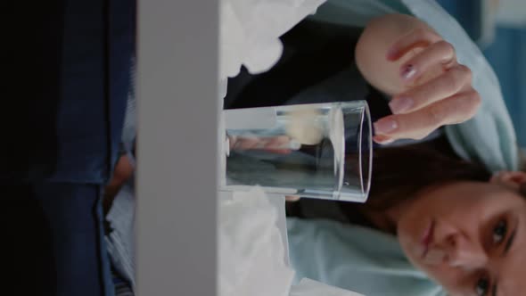 Vertical Video Close Up of Woman Putting Effervescent Pill in Glass of Water