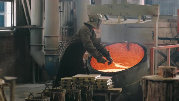 Steelmaker Agitates the Molten Metal in the Melting Furnace and Removes Slag
