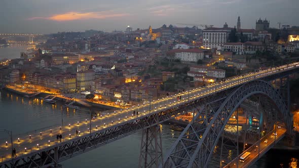 Evening Porto with Dom Luis I Bridge Over Douro River. People Walking Along the Illuminated Bridge