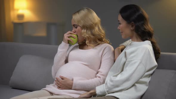 Pregnant Lady Eating Apple and Talking With Friend