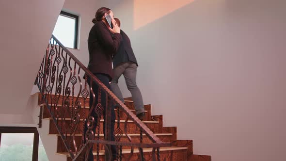 Furious Office Executive Talking Phone Walking on Stairs