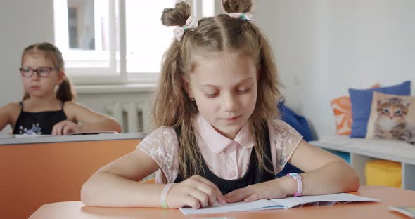 Portrait School Kid Siting on Table Doing Homework School and Home Schooling