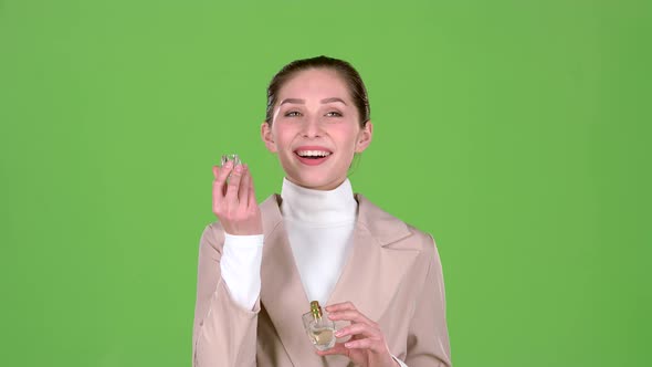 Seller of Cosmetics Advertises a Pleasant Fragrance of Perfume. Green Screen. Slow Motion