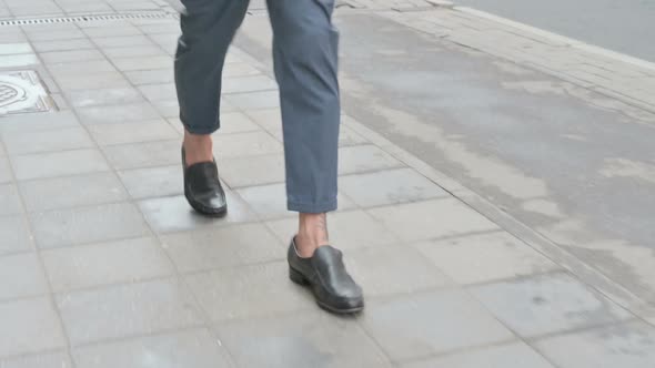 Close Up Male Feet Walking on Pavement