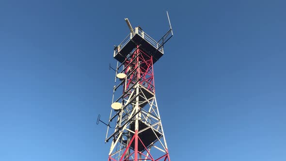 Red Radio Beacon Against Blue Sky