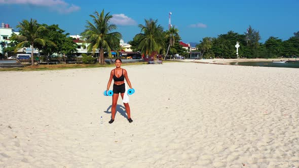 Modern happy ladies relaxing spending quality time at the beach on sunny blue and white sand