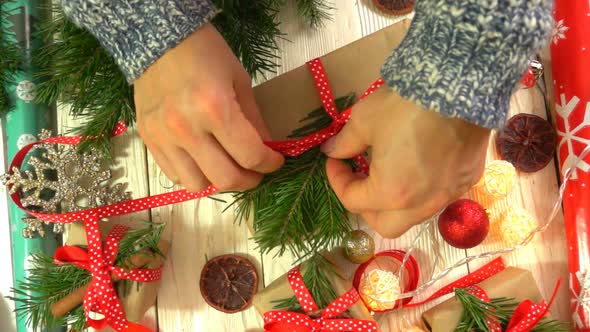 Woman is Wrapping Christmas Presents on the Table Concept of Preparing for the New Year and