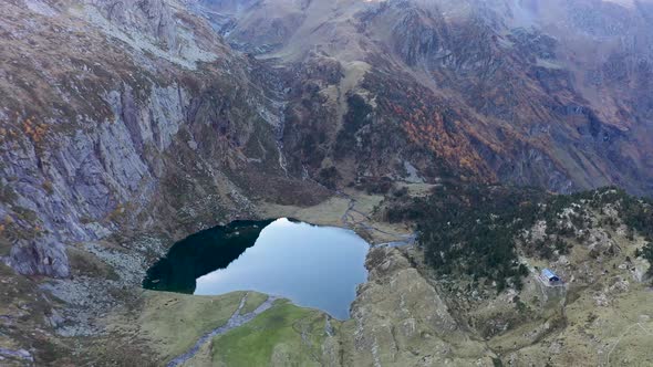 Lac d'Espingo lake panoramic high view in Haute-Garonne, Pyrénées mountains, France, Aerial orbit ab