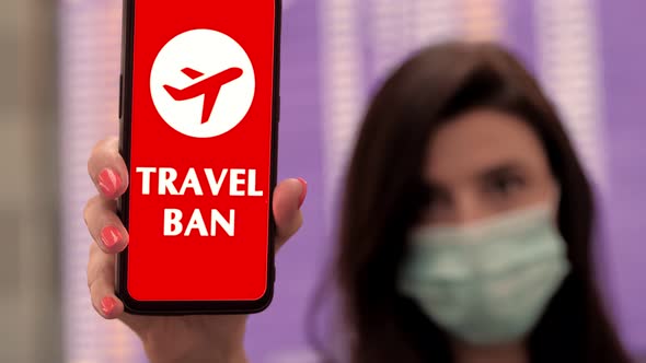 Close Up, Woman, in Protective Mask, Holds Smartphone with Airplane Icon, Travel Ban Sign, on Screen