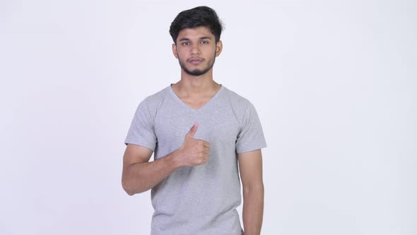 Young Handsome Bearded Indian Man Giving Thumbs Up