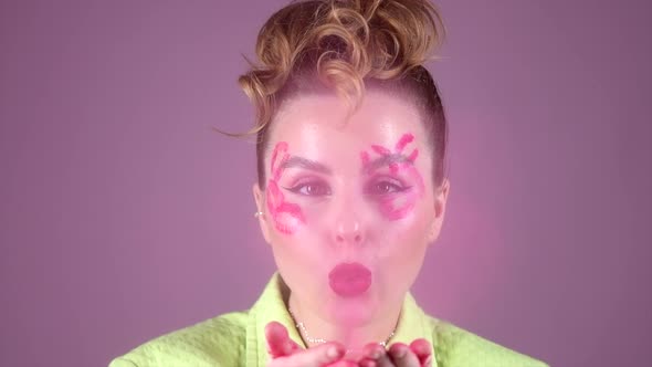 Young Beautiful Woman Professional Make Up Artist with Lipstick Marks Smile at Pink Background