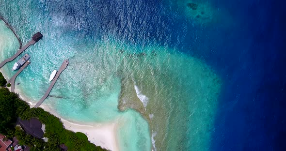 Wide drone island view of a sunshine white sandy paradise beach and aqua blue water background 