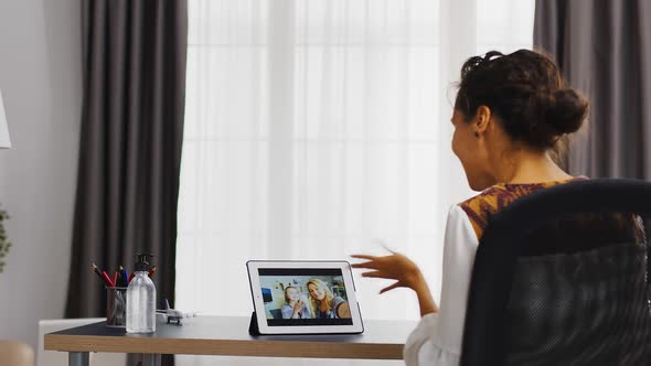 Cheerful Woman in a Video Call on Tablet Computer