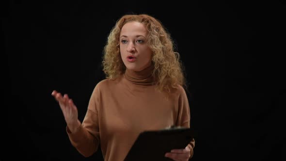 Emotional Caucasian Woman Talking Gesturing Standing at Black Background