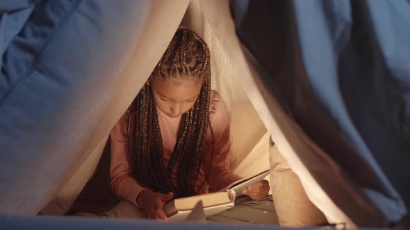 African Girl Reading Book in Pillowfort