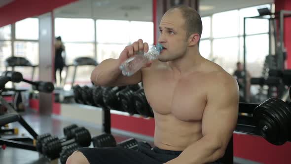 Sportive Man Tired After Active Training in Gym, Enjoying Gulp of Fresh Water