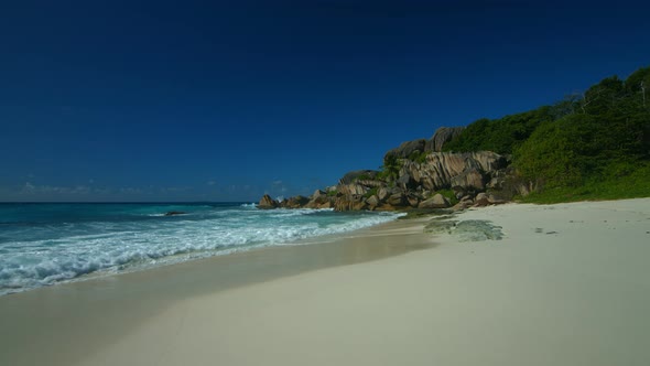 Walking on Wide Empty Sandy Beach on a Seychelles Island