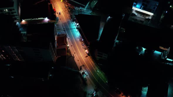 Aerial night illuminated city view Pathong Thailand road skyline.Traffic aerial panorama. Clip. Brig