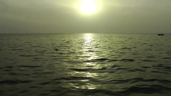 Golden Sunset Rays With Fishing Boat Floating