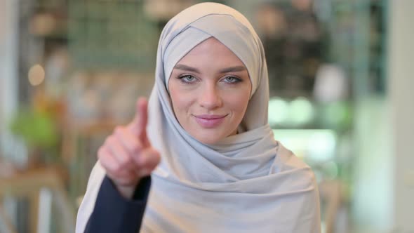 Portrait of Assertive Young Arab Woman with Pointing with Finger