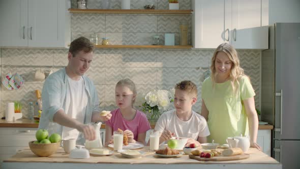 Happy Family Having Healthy Breakfast at Home