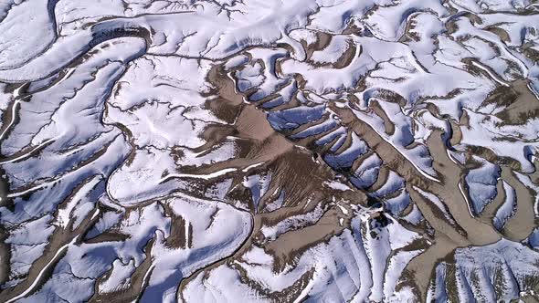 Rotating aerial view of desert terrain during winter in Utah