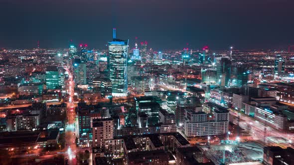 Aerial Hyperlapse of Warsaw Business Center at Night Skyscrapers and Palace of Science and Culture