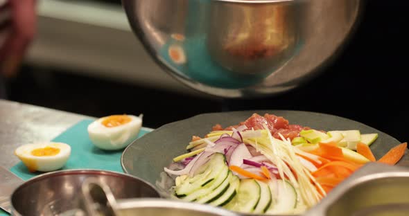 Chef Preparing A Healthy Asian Salad With Tuna Meat In The Kitchen. - close up shot