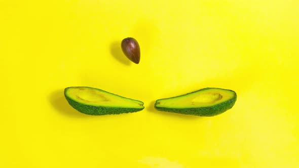 Avocado is split into two halves. Halves throw a bone to each other, as if playing tennis. Looped vi