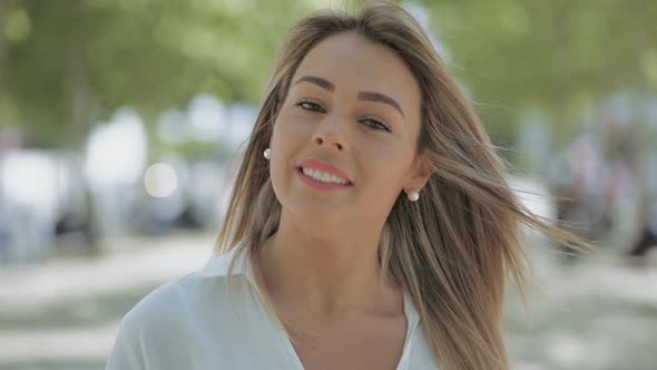 Girl Walking on Street and Looking at Camera