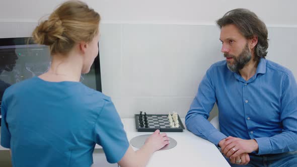 Patient Man and Female Doctor Have a Discussion