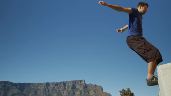 Caucasian man practicing parkour