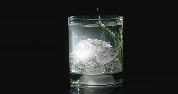 Man's Hand Touches the Glass with Cocktail and the Glass Lights Up Cocktail on the Black Background
