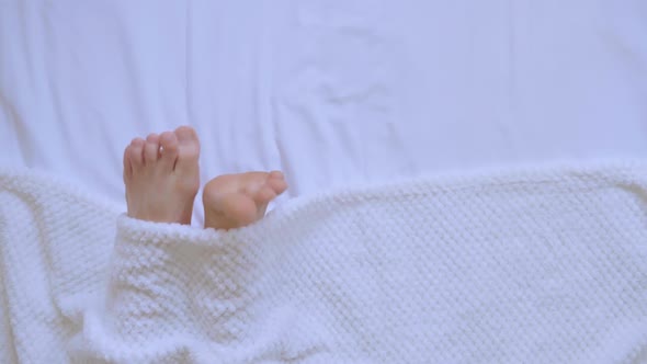 Top View Male Legs Under a White Blanket Person