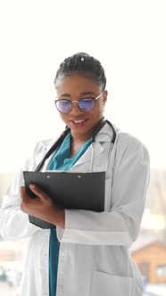 African American Young Medical Worker with Notepad