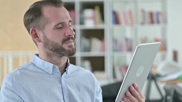 Portrait of Young Man Doing Video Chat on Tablet 