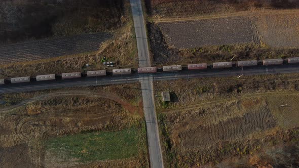 Top View Freight Train Passing Railway Crossing