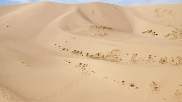 Aerial dolly of sand dune and blue sky in gobi desert in sunny daytime