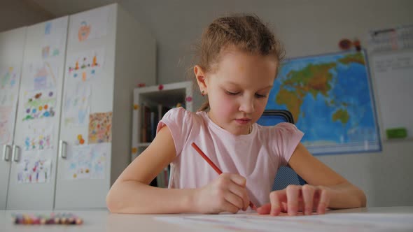 Little Kid Girl Study at Home Drawing Picture By Pencils Coloring Picture