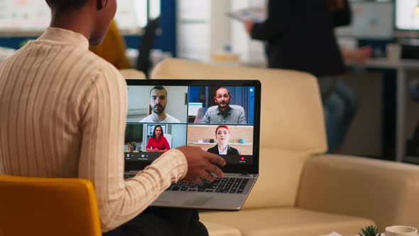 Over the Sholder Shot of Employee Talking with Partners Using Video Call